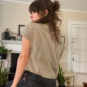 Casual, cropped, olive green button-down top.